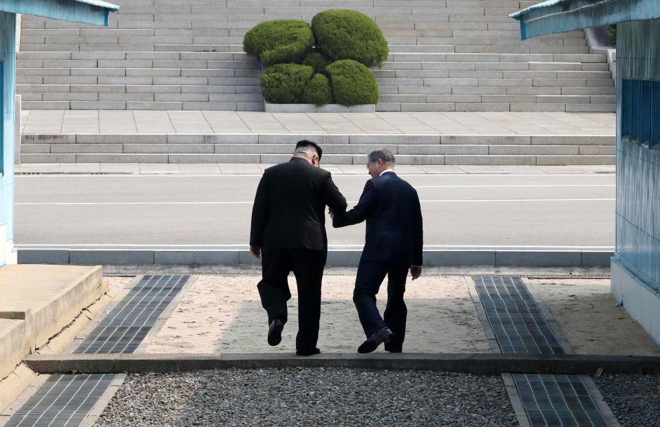 The pair held hands as Kim became the first North Korean leader to enter the South for six and a half decades