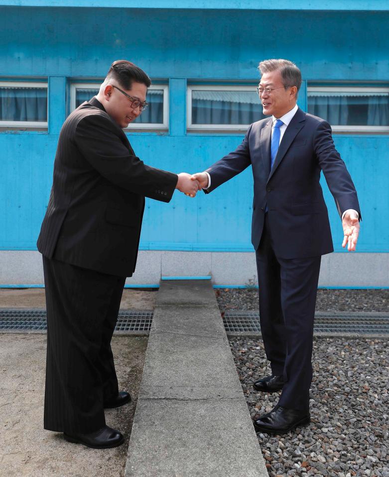 Kim Jong-un and Moon Jae-in shake hand's across the 38th parallel for the first time