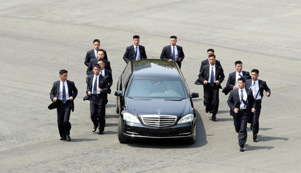 The North Korean dictator was flaked on all sides as he was driven off for lunch