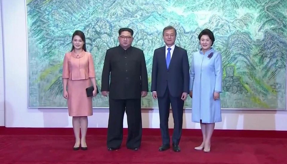 The leaders pose with their wives ahead of announcing their plans to reunify the nation