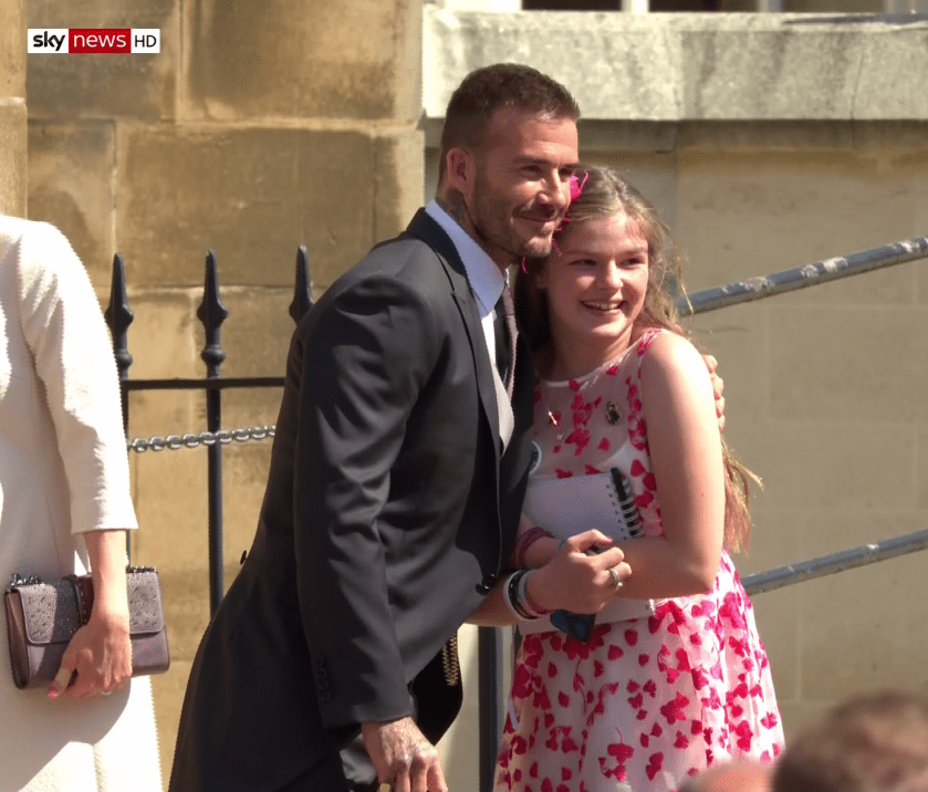 David Beckham, looking dapper in a suit, smiles with fan Amelia, who survived the devastating Manchester Arena terror attack