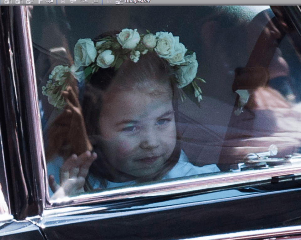 Adorable bridesmaid Princess Charlotte waves out of the window of the car as she is taken to the chapel