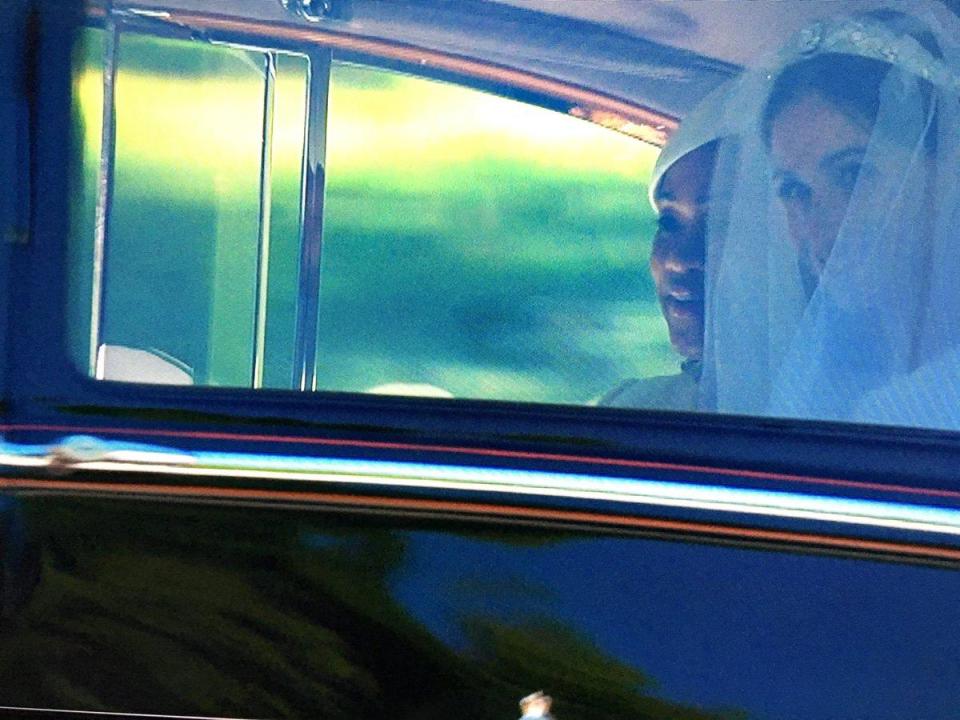 The American actress peered out of the vintage car, giving a sneak peek of her wedding dress ahead of the ceremony