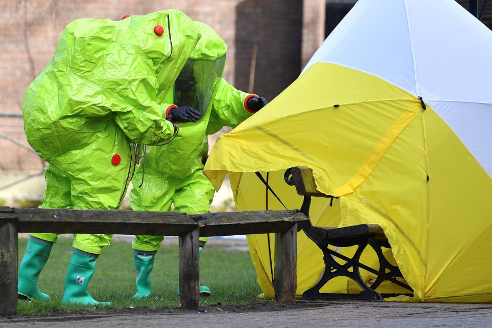 Emergency service workers covering the bench in Salisbury where the Skripals were found
