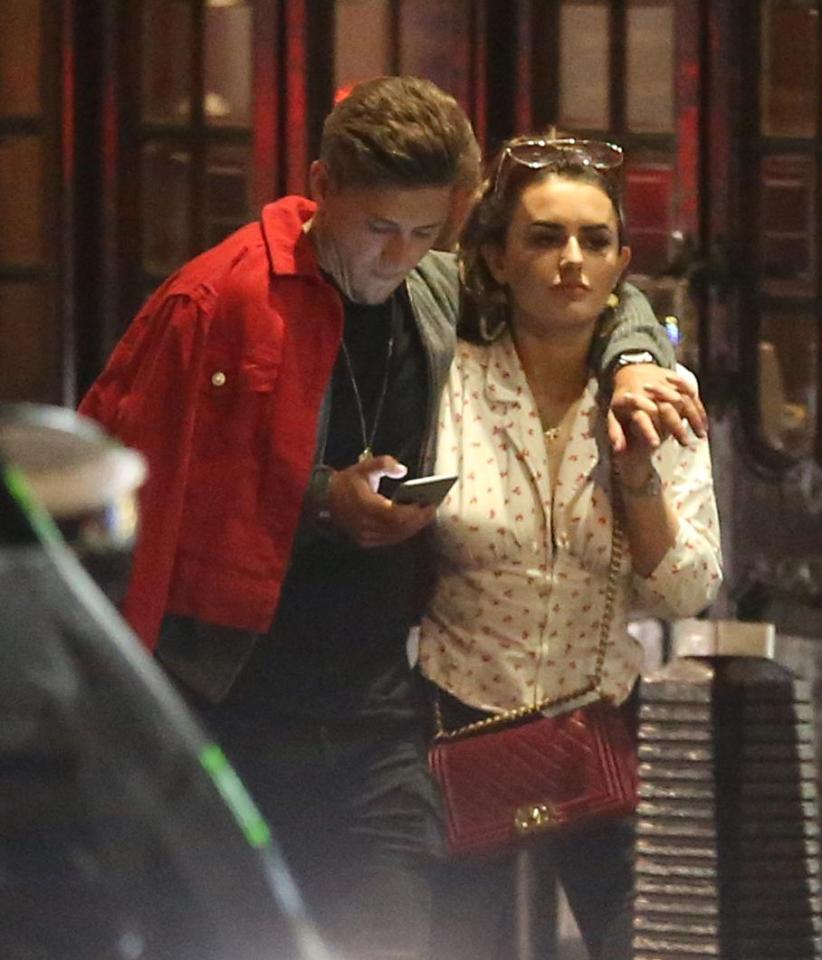  The pair linked hands as James put his arm round Amber and texted on his phone at the same time