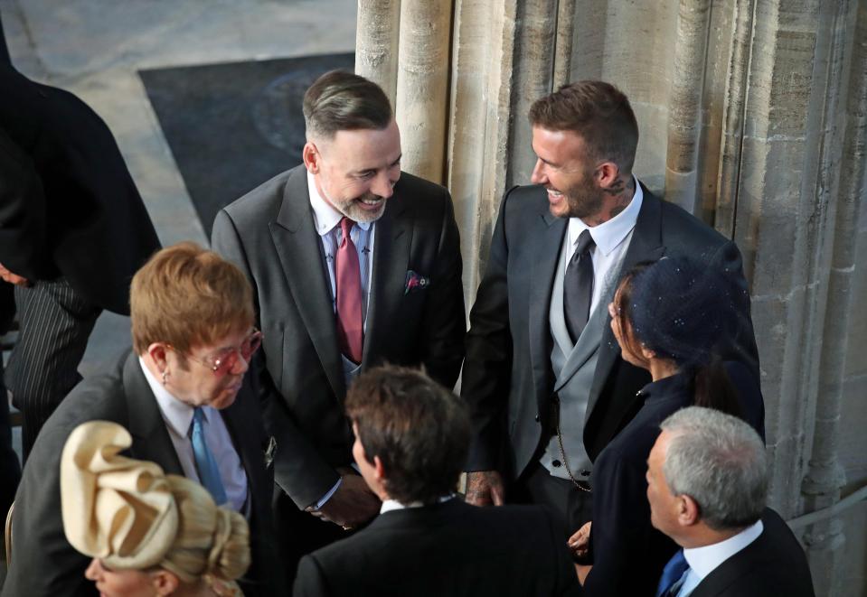 David and Victoria Beckham speak with Sir Elton John and his husband David Furnish at the chapel