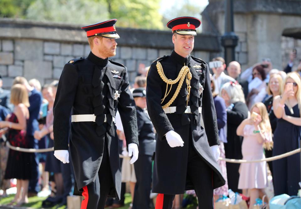 Prince Harry shares a joke with his brother and best man Prince William as they head into the chapel