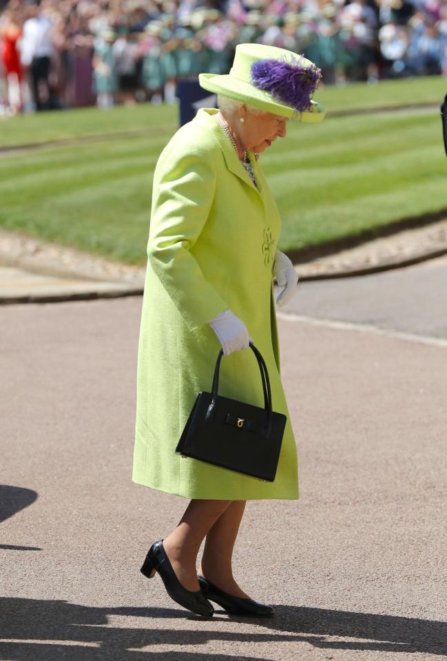 The Queen walks into the chapel, having lent a tiara to Meghan for the big day
