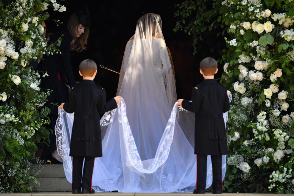  Two of Meghan's pageboys held the bride's veil as she walked into the chapel