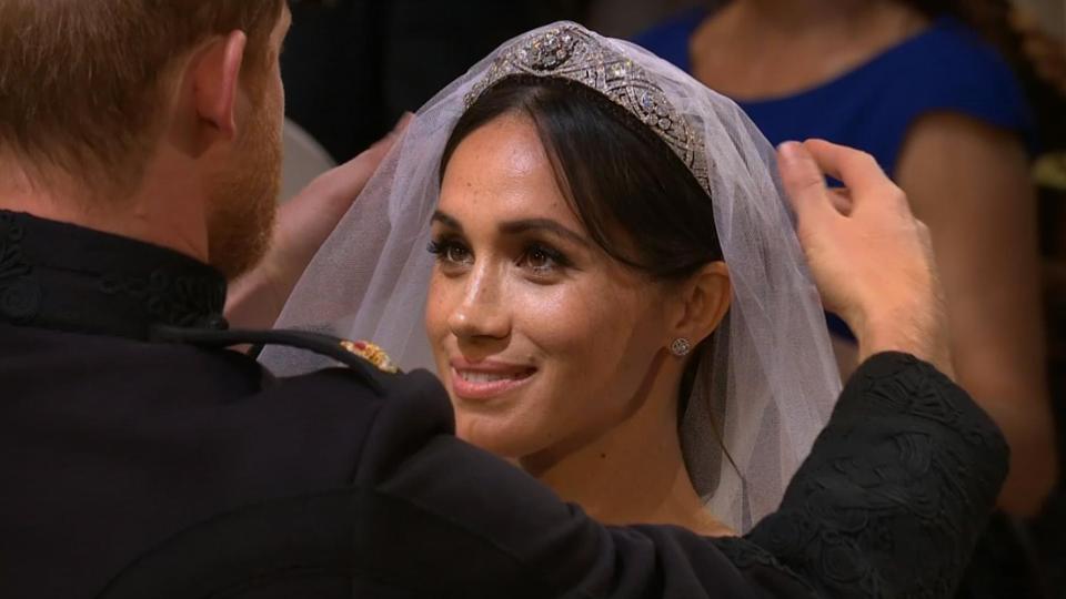 Meghan glowed as Prince Harry moved her veil from her face in the romantic ceremony
