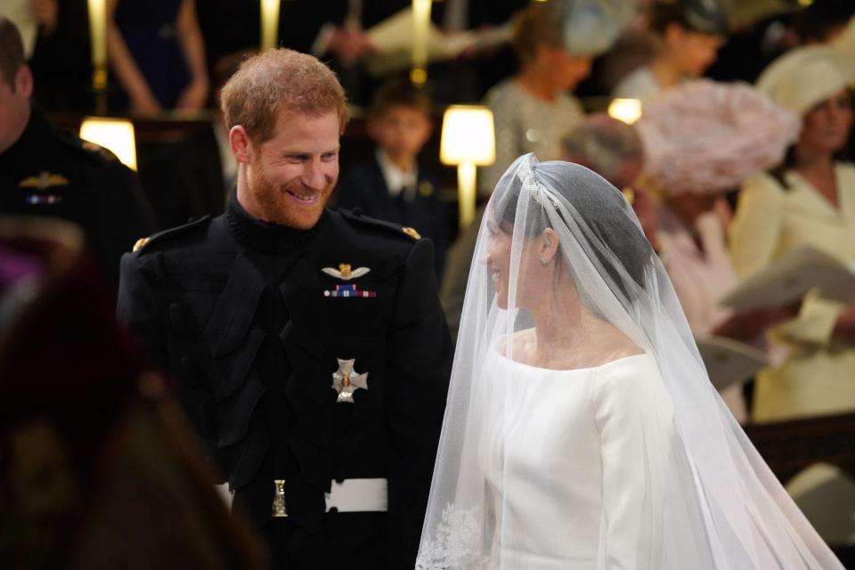 Harry gazes at Meghan, with the couple tying the knot just months after becoming engaged in their whirlwind romance