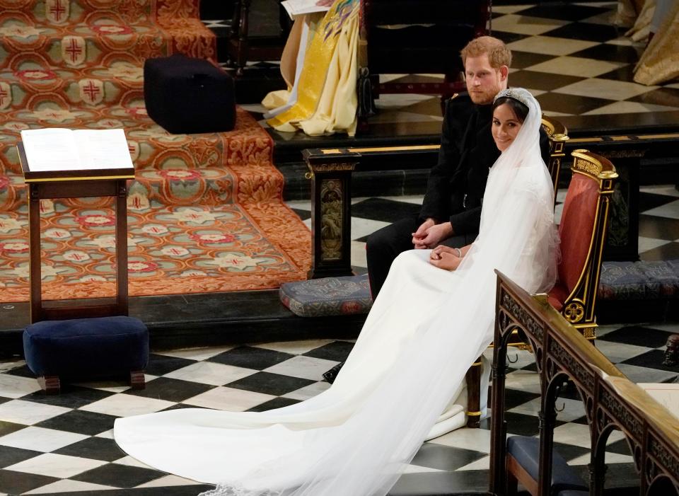 Meghan's veil wrapped around her as she sat next to her new husband