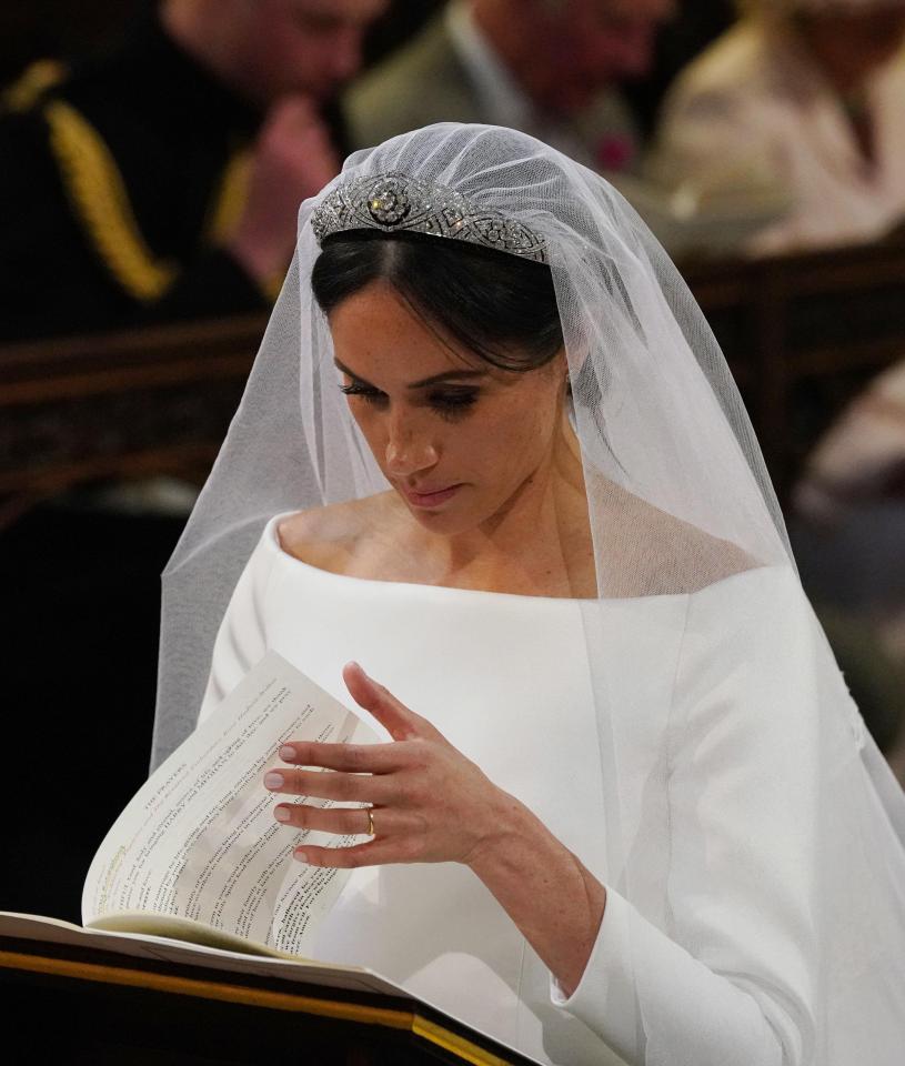 Meghan shows off her new wedding ring which was made specifically for the new bride from Welsh gold gifted to her from the Queen