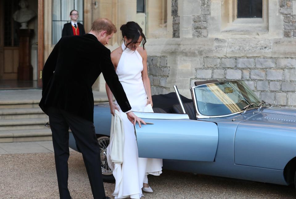  Prince Harry opens the car door for his bride as they leave for their reception tonight