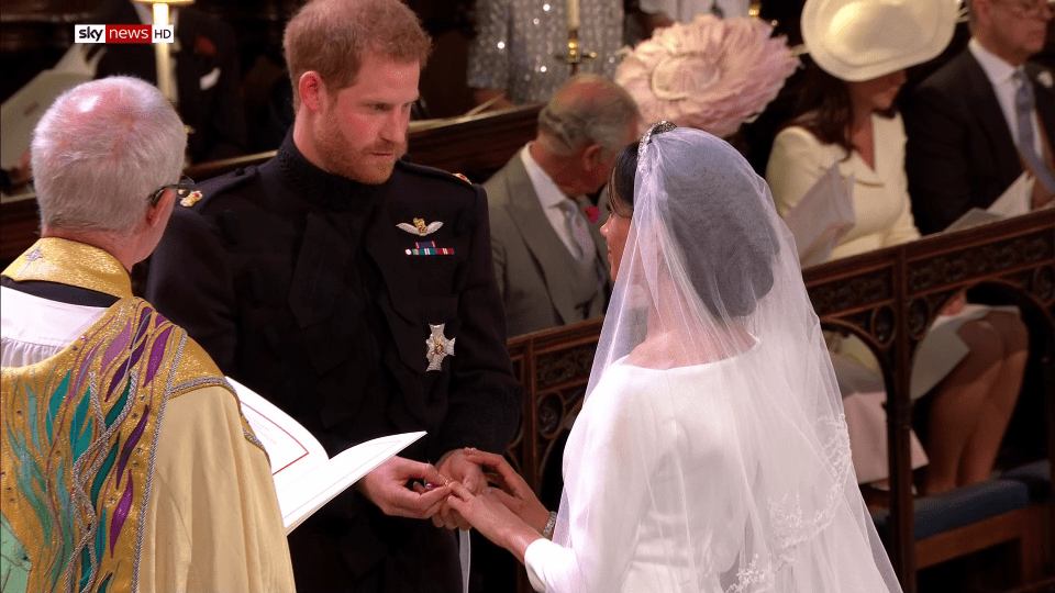 Prince Harry slipped a ring onto his bride's finger in front of a star-studded crowd