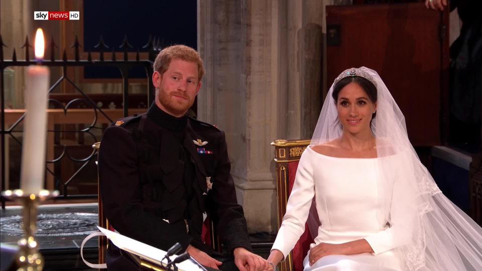 Prince Harry holds his brides hand as they today tie the knot in the biggest wedding of the year