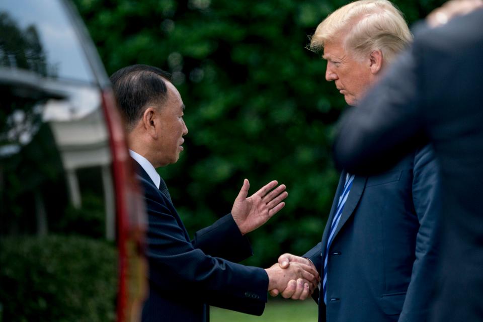 Trump shakes hands with Kim's closet aide who was dispatched to Washington to smooth things over