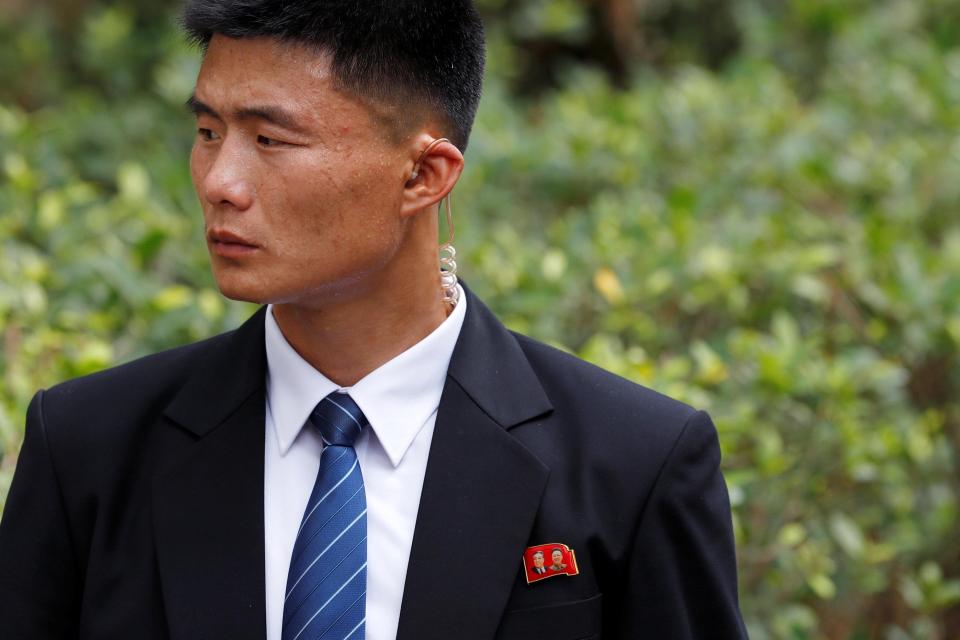  A North Korean security officer waits for the arrival of outside the St Regis hotel