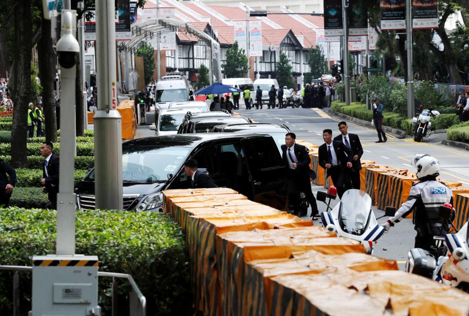  Security officers flank the car of the North Korean leader