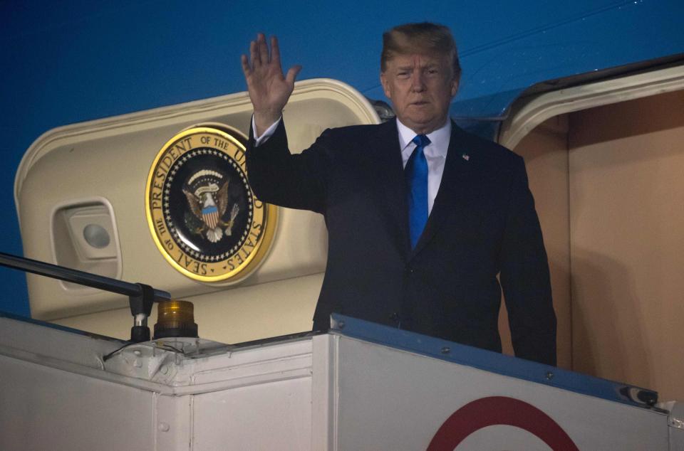  US President Trump waves after landing at Paya Lebar Air Base in Singapore ahead of his showdown with Kim Jong-un