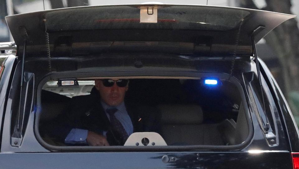 They've got his back covered... a Secret Service sniper can be seen in the boot of a motorcade limo 