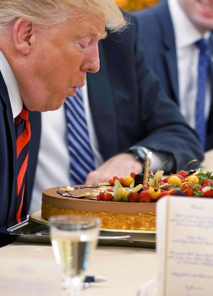 The president blew out a candle on the elaborate gateaux at the official residence of the President of Singapore, the Istana 