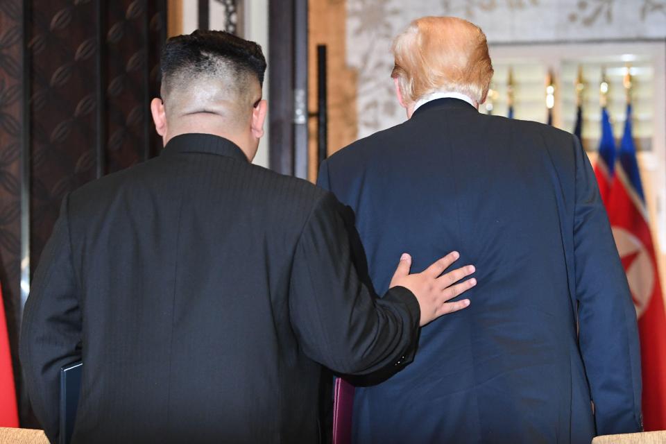  Kim Jong-un put his hand on President Trump's back as they leave after signing the agreement