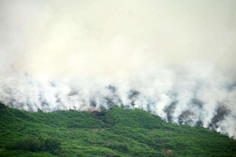 The enormous wild fire in Greater Manchester has prompted a warning to residents to keep windows and doors closed