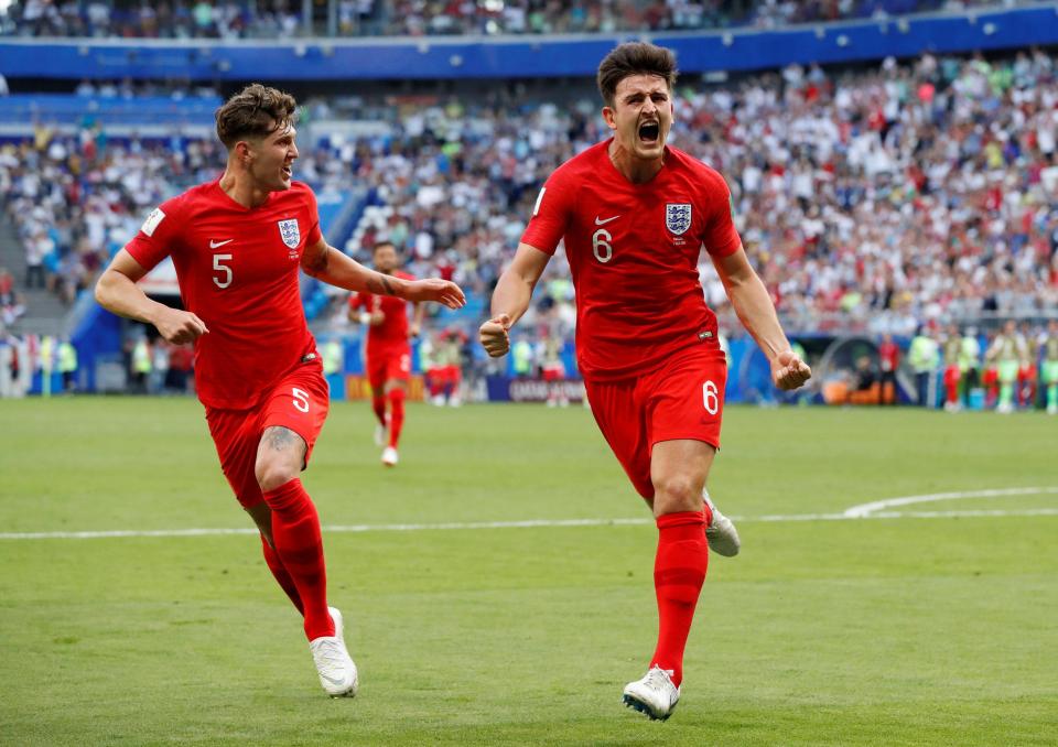 Harry Maguire is chased by John Stones as the celebrations after his goal begin