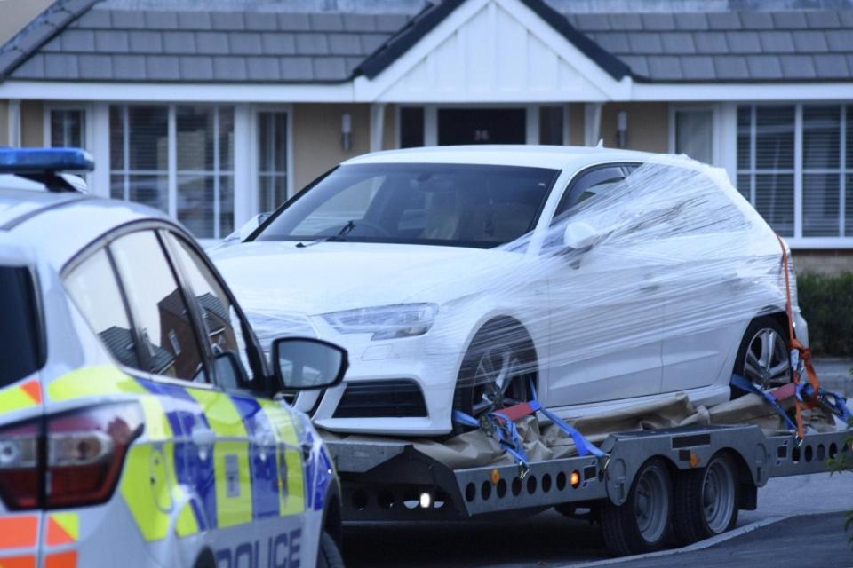  Cops wrapped clingfilm around a white Audi in a residential street as the poison probe spread to Swindon last night