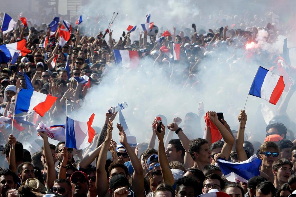 France supporters light flares as they celebrate their World Cup win