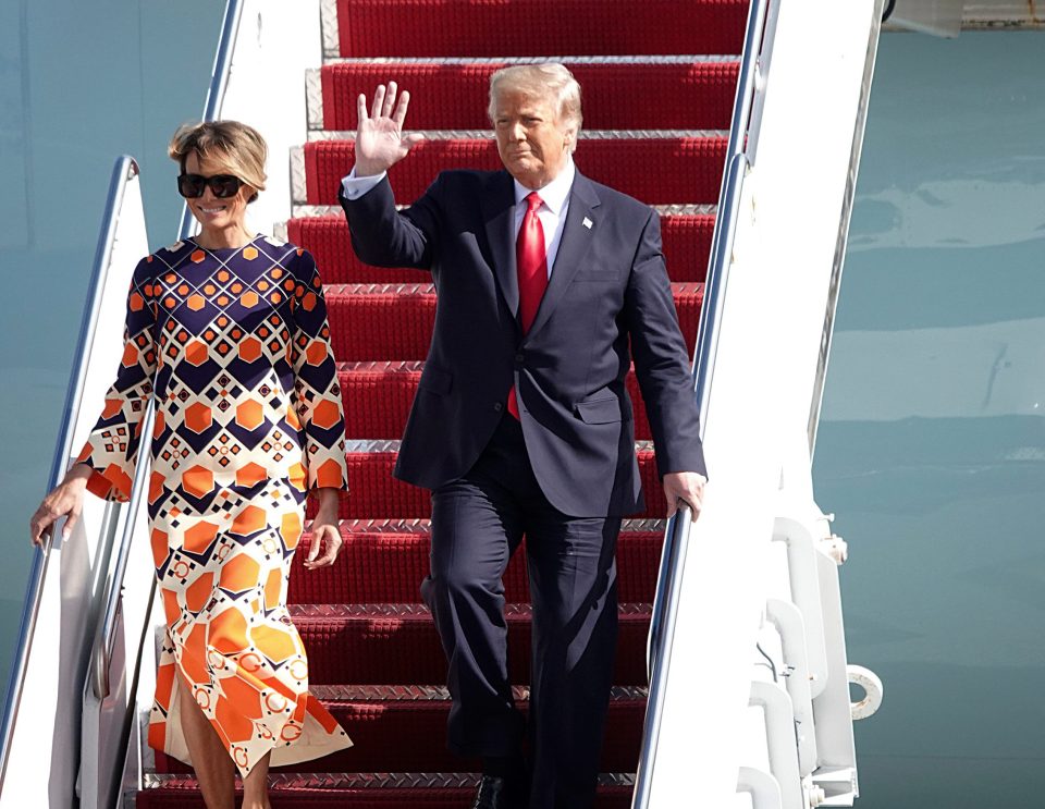  President Donald Trump waves to a handful of supporters as he arrives with first lady Melania Trump at Palm Beach International Airport