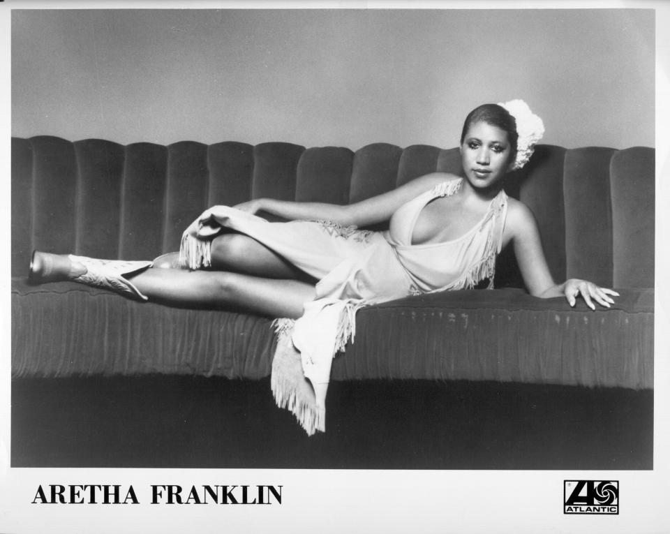 Soul singer Aretha Franklin poses for a portrait lying on a couch in 1973