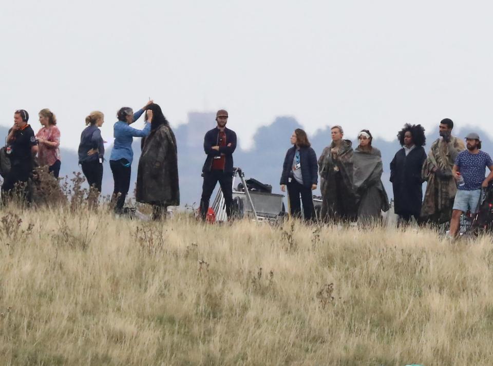  The extras were given final touches by the costume and hair and make up departments between takes