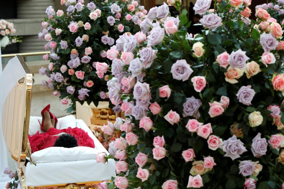 The soul legend lies in state surrounded by flowers 