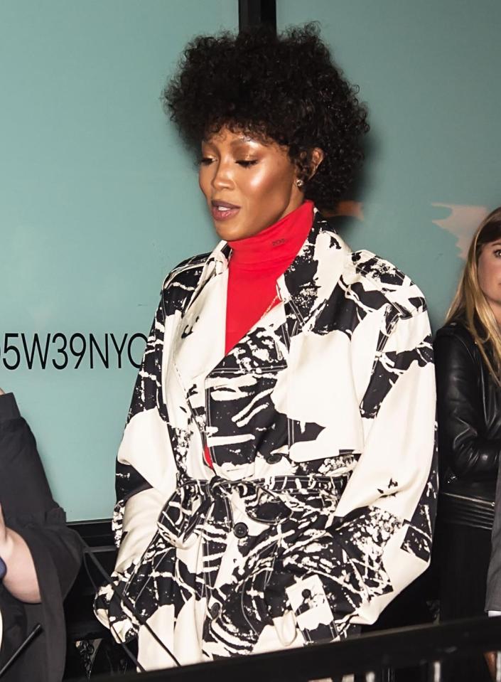  Naomi stood out from the crowd although she was covered up by a coat and turtle neck jumper