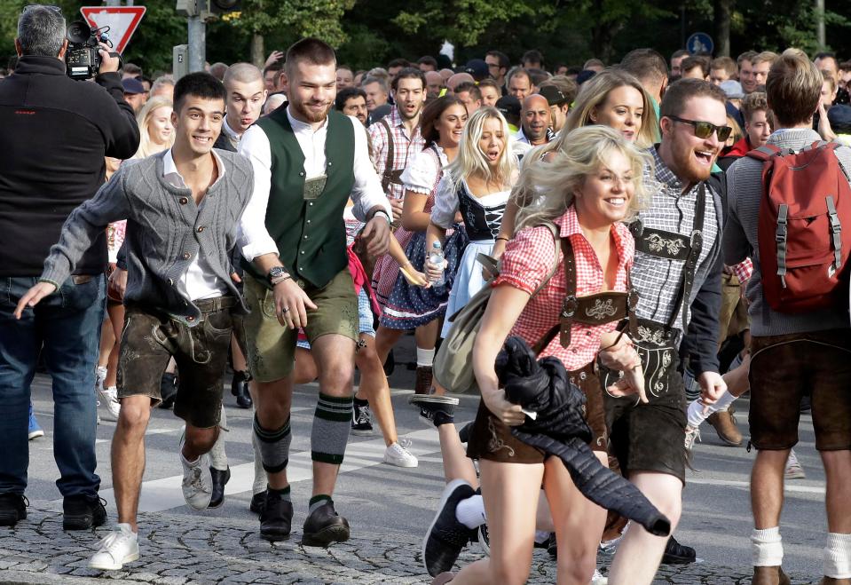 People run to enter the 185th Oktoberfest event, the biggest beer festival in the world