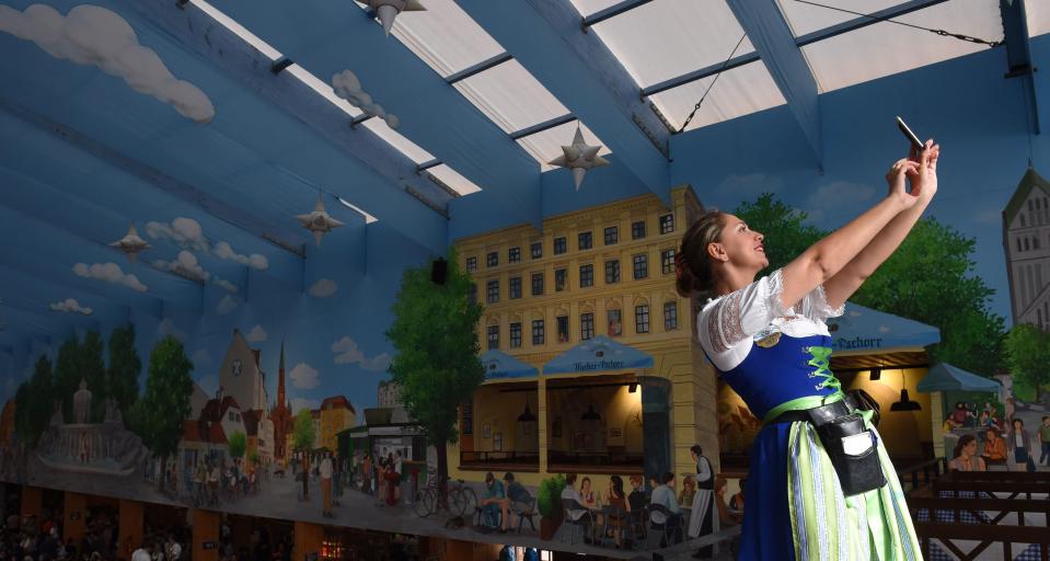 A German waitress takes a selfie as the first visitors arrive to book tables