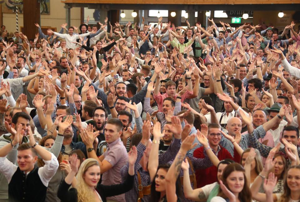 Visitors cheer at the opening day of the 185th Oktoberfest in Munich