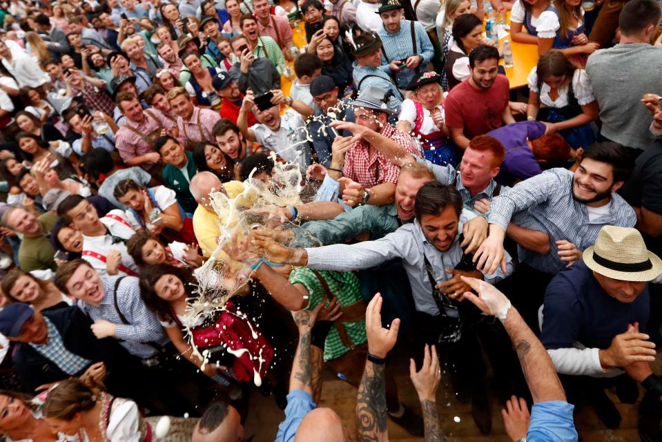 People battle for a glass of beer during the opening of the 185th Oktoberfest