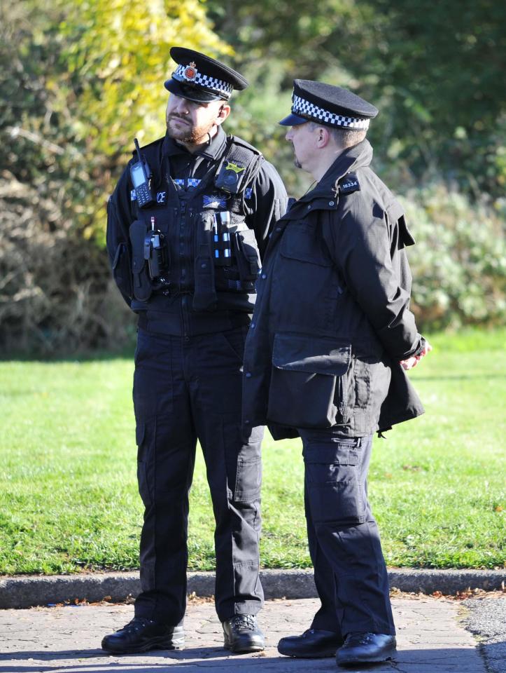 Police watch on as the reburial takes place