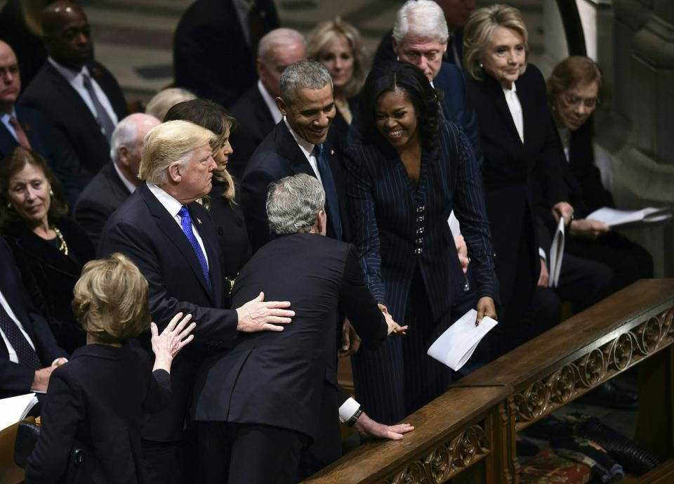  George Bush hands Michelle Obama a cough drop - a running joke that started at John McCain's funeral