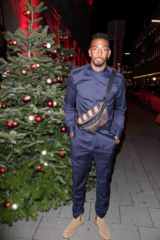  Bayern star Jerome Boateng posing in front of a Christmas tree