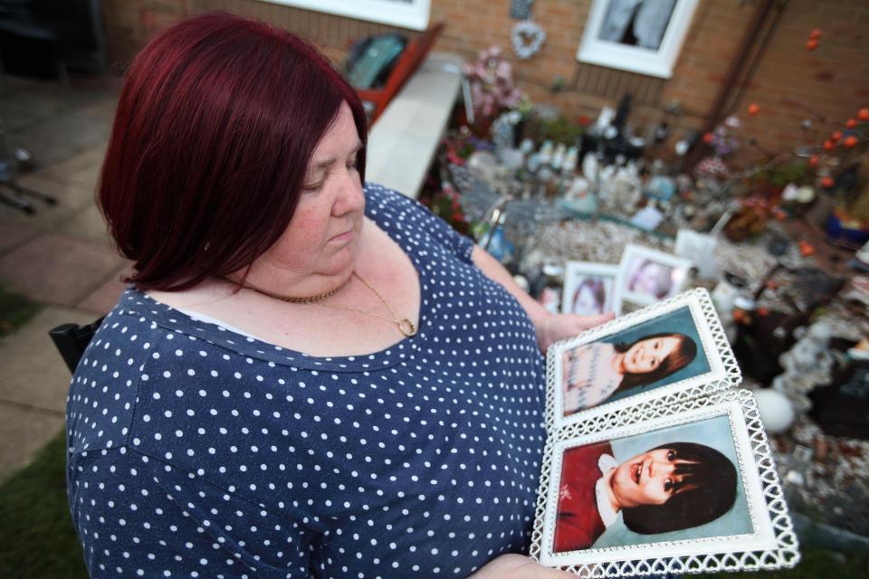  Michelle Johnson in her memory garden with pictures of her daughter, Karen, and friend Nicola