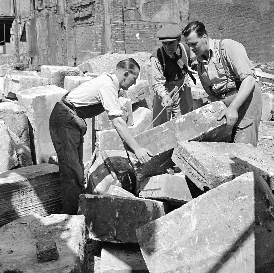  Men worked tirelessly to lift stone and rubble to help rebuild churches which had been knocked down