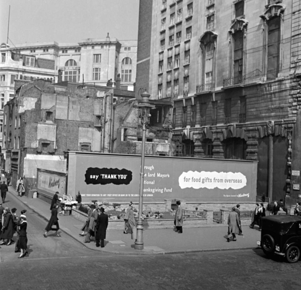  The longest advertisement hoarding in London stands on a bombed site near Piccadilly Circus, with a little flower garden at its foot