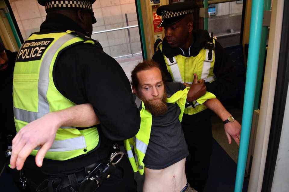 The protester was eventually removed and taken from the scene at Canary Wharf