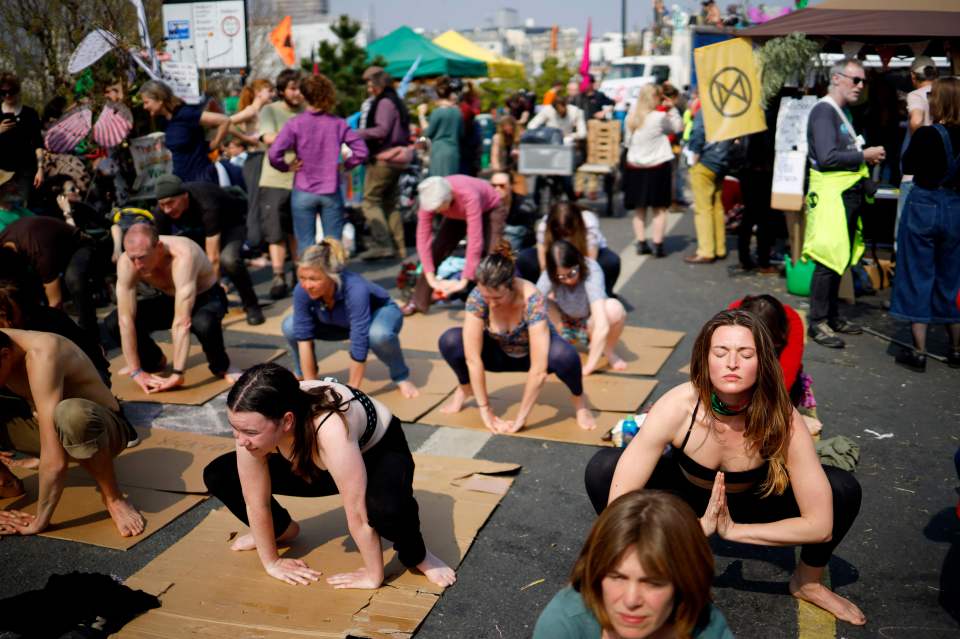 Climate change protestors practice yoga on Waterloo Bridge
