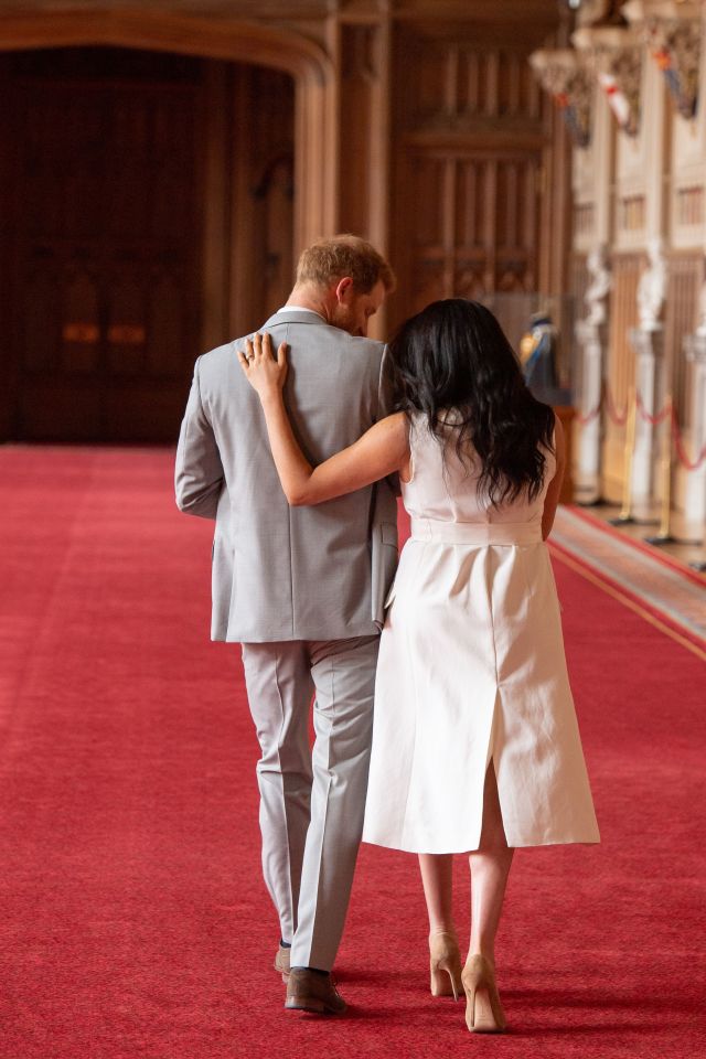  Mum Meghan Markle puts a protective arm around her 'two guys'