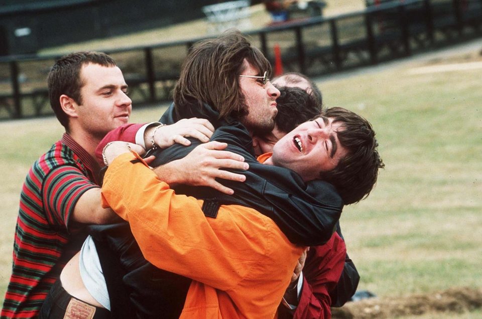Oasis' drummer Alan White with Liam and Noel showcasing the 'pure anarchic Gallagher' spirit in 1996